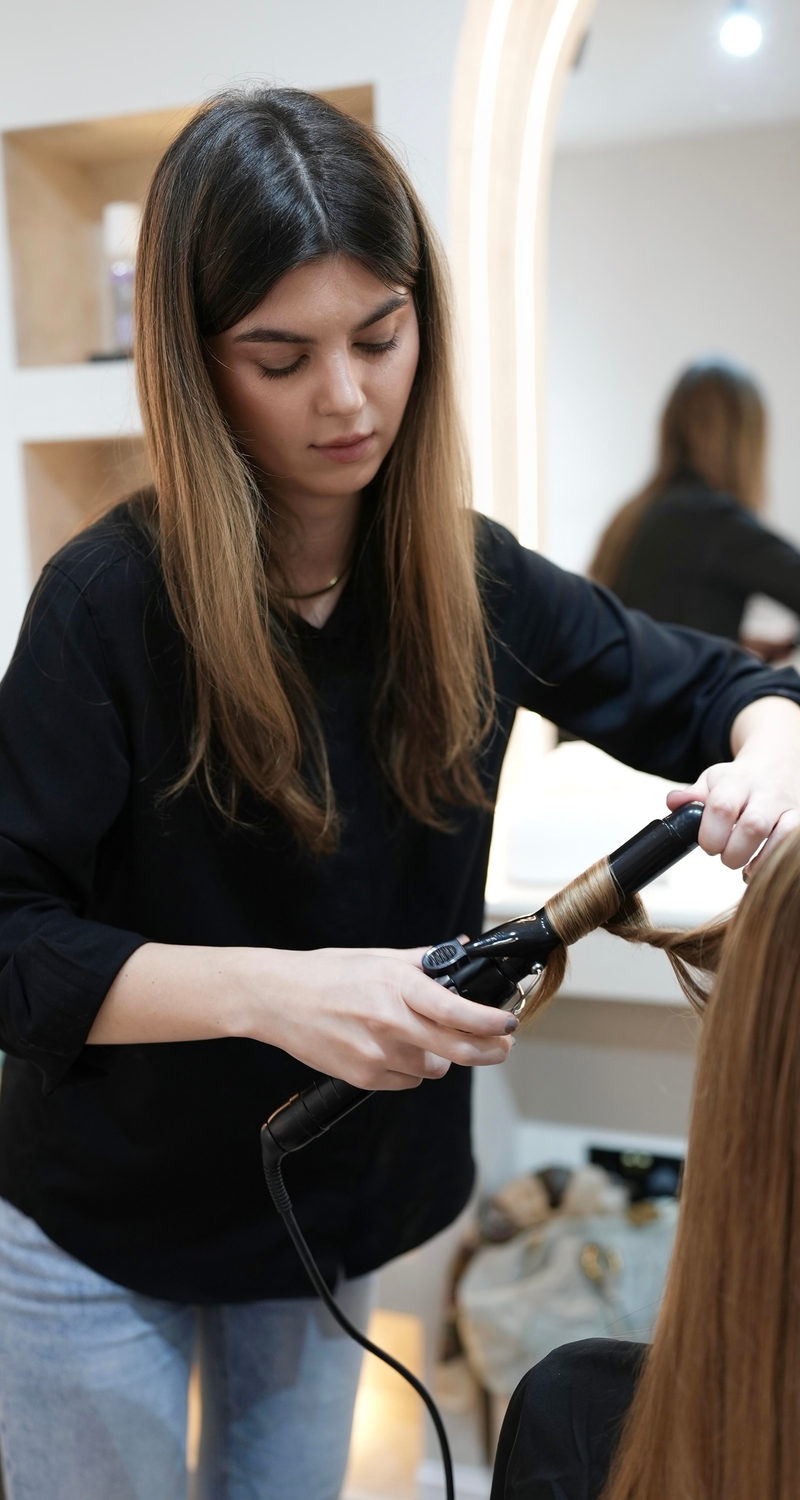 A stylist finishing a client&rsquo;s hair at Blanche Beauty in Fitzrovia